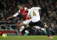 Arsenal's Theo Walcott (L) vies with Swansea City's Chico Flores (R) in London on January 16, 2013